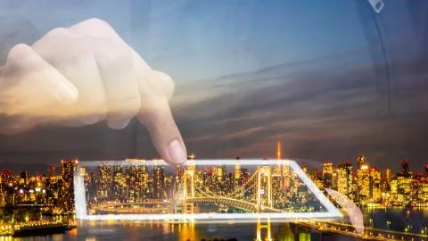 Double exposure of hand using tablet with tokyo city Stock Photos