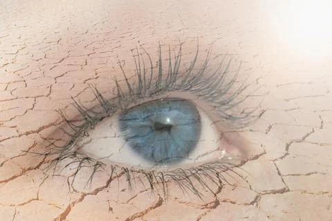 Double exposure of human eye in dry land on the background. Global warming an Фото