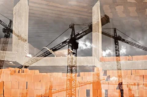 Double exposure image of tower cranes and working construction site 스톡 사진