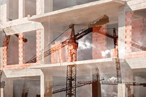 Double exposure image of tower cranes and working construction site 스톡 사진