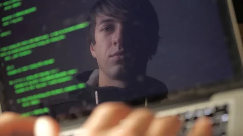Double exposure: man hacker in glasses working at a laptop. Programmer writes Stock Footage 103817545