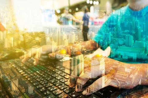 Double Exposure of Man with Loptop computer with Metro city Building Stock Photos