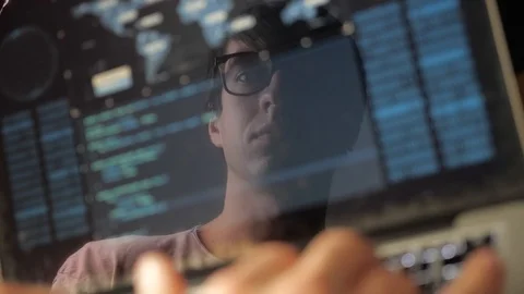 Double exposure: man programmer in glasses working at a laptop. Programmer Stock Footage 103812970
