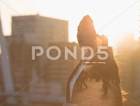 Double exposure of young woman and cityscape Stock Photos