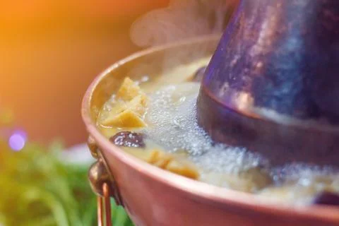 Double flavor hot pot on the table Stock Photos