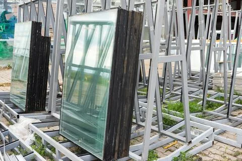 Double-glazed windows at a construction site. Double glazed glass window stac Stock Photos