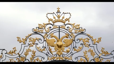 Double headed eagle the symbol of Russian Empire Luxury Golden fence gate close Stock Footage 118860858