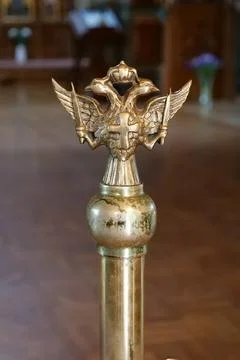 Double-headed eagle with two swords, cross and crown in the church Stock Photos