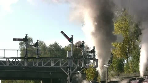 Double headed steam train leaving under signal gantry Video stock 22323174