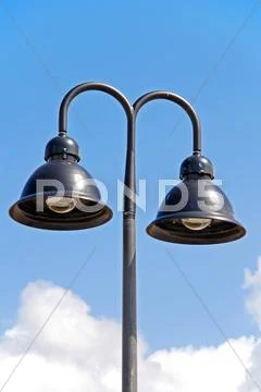 A double hooded street light with blue sky background Stock Photos