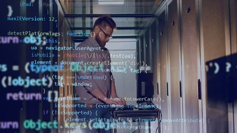 Double image of the engineer working on the laptop and the computer code Stock Footage 114739976