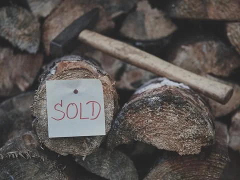 Double-Layer Firewood Step with SOLD Tag and Slightly Blurred Hammer Stock Photos