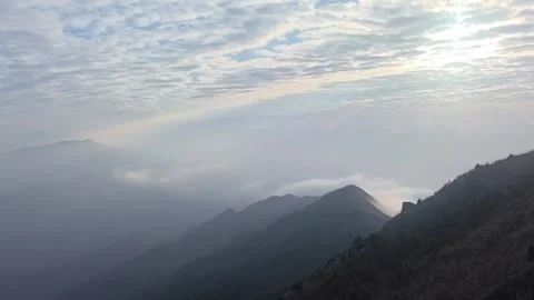 Double Layer Sea of Clouds Flowing Over Mountain Ridge Stock Footage 332626361
