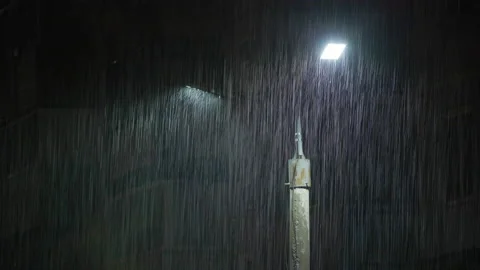 Double led panel lamppost under heavy rain at night. Midsize view of raindrops Video stock 203176823