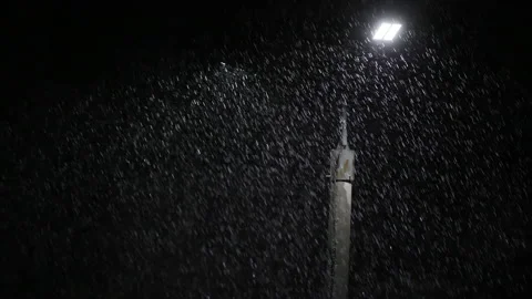 Double led panel lamppost under heavy rain at night. Midsize view of raindrops Video stock 204026651