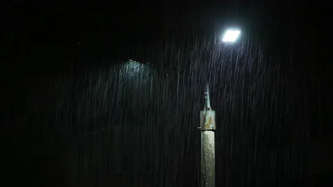 Double led panel lamppost under heavy rain at night. Midsize view of raindrops Video stock 206508850