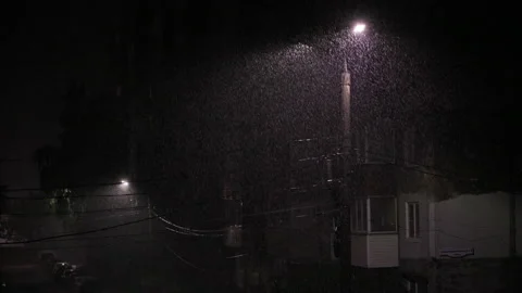 Double led panel lamppost under heavy rain at night. Midsize view of raindrops Video stock 206523140