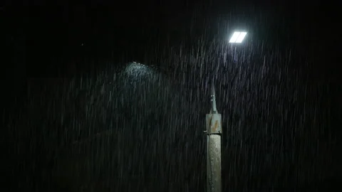 Double led panel lamppost under heavy rain at night. Midsize view of raindrops Video stock 208238773