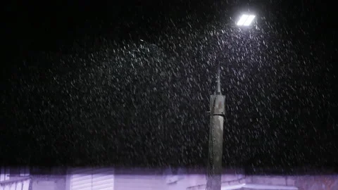 Double led panel lamppost under heavy rain at night. Midsize view of raindrops Video stock 209519311