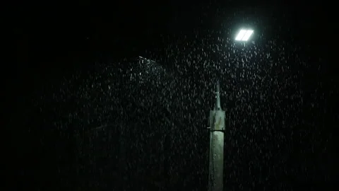 Double led panel lamppost under heavy rain at night. Midsize view of raindrops Video stock 209970474