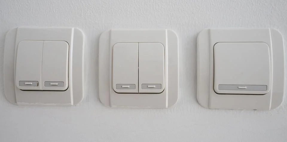 Double light switch on gray wall Stock Photos