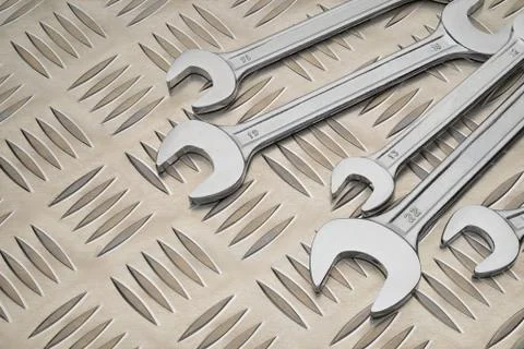Double open end spanner on metal plate with diamond pattern Stock Photos