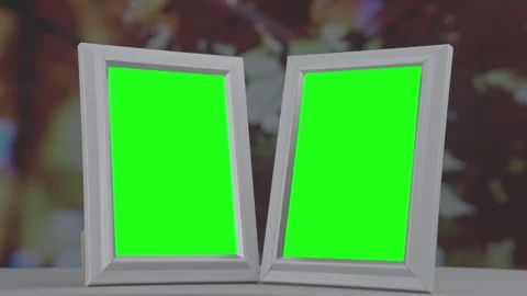 Double photo frames with green chroma key empty space standing at windowsill Stock Footage 274206200