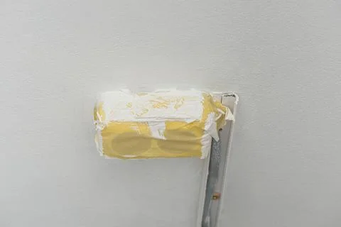 Double power socket covered with masking tape during wall painting Stock Photos