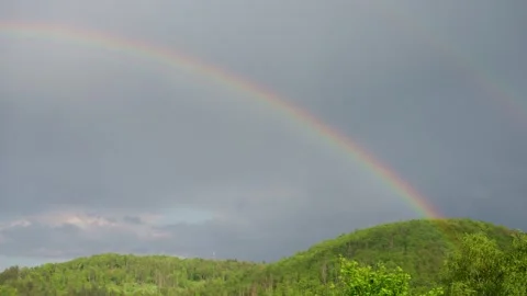 Double rainbow above against dark stormy sky, in Germany. Slow motion. Scenic. Stock Footage 255314941