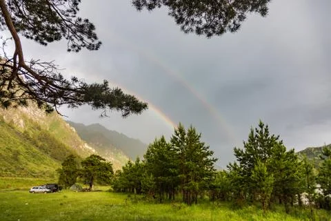 Double rainbow against the mountains and the sky after the rain , Altai, Russ Stock Photos