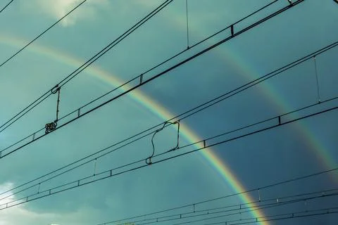 Double rainbow behind the train cables Stock Photos