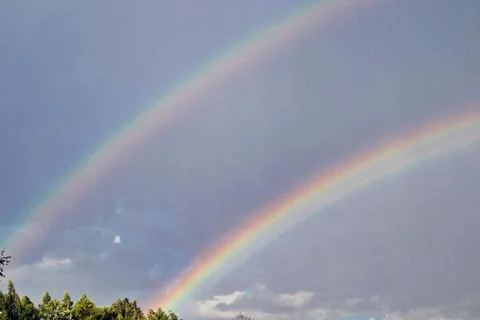 Double rainbow in a cloudy sky after heavy rain Foto stock