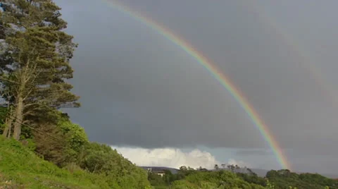 Double rainbow in dark cloudy sky Video stock 23017024