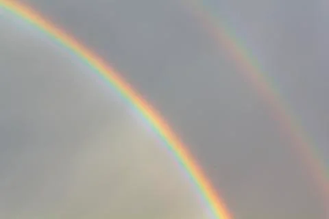 Double rainbow on dark sky Stock Photos