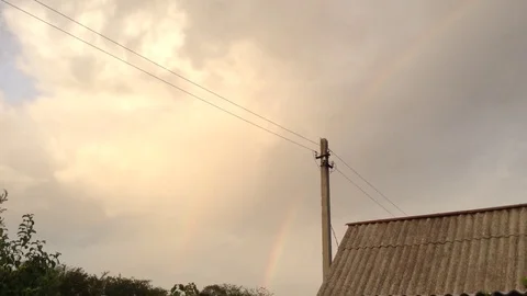 Double Rainbow In the Grey Sky and House In The Village Stock Footage 106303238