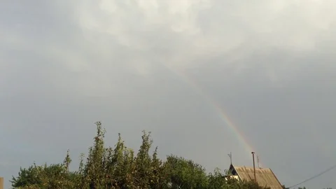 Double Rainbow In the Grey Sky and Green Trees In The Village 2 Stock Footage 106364314