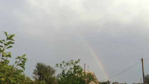 Double Rainbow In the Grey Sky and Green Trees &amp; House In The Village Stock Footage 106364316