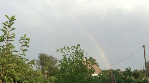 Double Rainbow In the Grey Sky and Green Trees &amp; House In The Village 4 Stock Footage 106417887