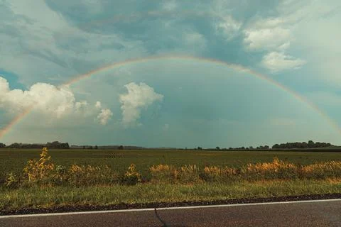 Double Rainbow Over Bean Field with Big Thunder Clouds Stock Photos