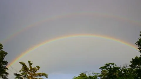Double rainbow over tree line in Augusta, Georgia Stock Photos