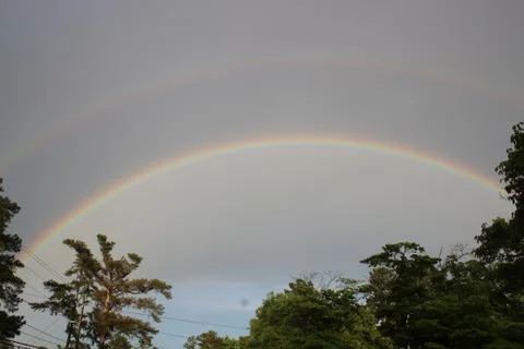 Double rainbow over tree line in Augusta, Georgia Stock Photos