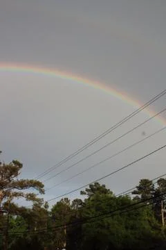Double rainbow over tree line in Augusta, Georgia Stock Photos
