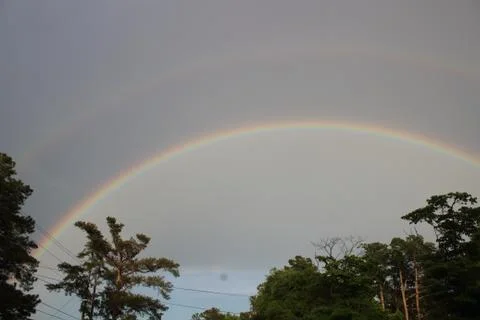 Double rainbow over tree line in Augusta, Georgia Stock Photos