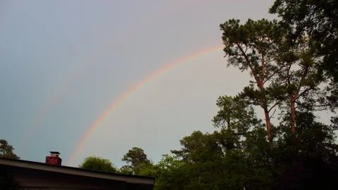Double rainbow over tree line in Augusta, Georgia Stock Photos
