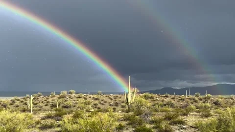 Double rainbow with rain falling in the Arizona desert Stock Footage 270617241