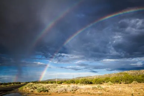 Double rainbow with rain mist during the monsoons near Kayenta, AZ Stock Photos