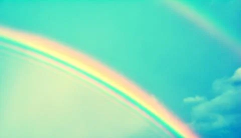 Double rainbow in sky with clouds Stock Photos