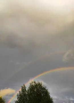 Double rainbow in the sky with clouds Stock Photos
