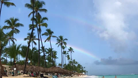 A double rainbow in the sky over a beach in Punta Cana, Dominican Republic. Stock Footage 142820619