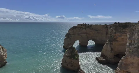 Double rock arch at Praia da Marinha in the Algarve on a sunny day Stock Footage 346650617